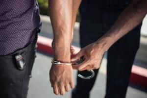 A wrist being hand cuffed.