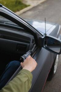 A man brandishing a gun from his car